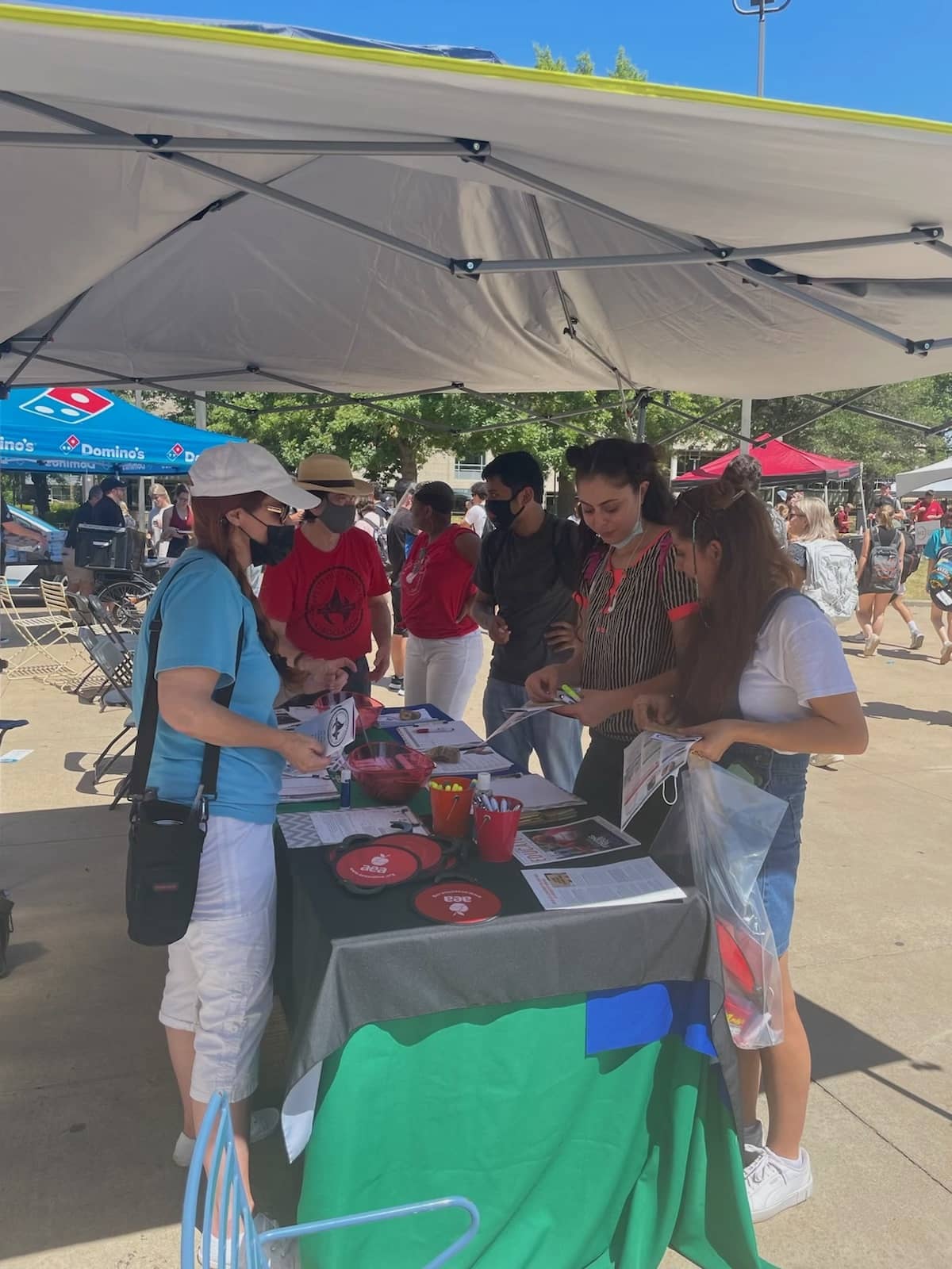 AEA UniServ Director Renee Johnson, Local 965 Secretary Ben Pollock and AEA Organizing and Field Services Manager Karla Carpenter answer questions of three students at UA's Razorbash fair Aug. 26, 2021.
